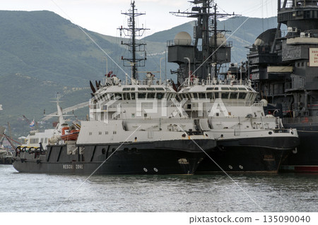 August 24, 2025: Rescue ships docked in the port of Novorossiysk, Russia, with mountains in the background, illustrating maritime safety, port operations and Black Sea coastal activity August 24, 2025: Rescue ships docked in the port of Novorossiysk, Russia, with mountains in the background, illustrating maritime safety, port operations and Black Sea coastal activity 135090040