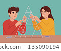 Man and woman are building a house of cards 135090194