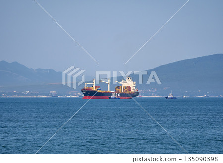 August 12, 2025: Cargo ship MSC Pamira III entering the port of Novorossiysk, Russia, navigating through calm waters with port activity in the background August 12, 2025: Cargo ship MSC Pamira III entering the port of Novorossiysk, Russia, navigating through calm waters with port activity in the background 135090398