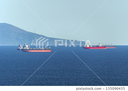 August 22 2025 Oil tankers waiting for loading in Tsemesskaya Bay near Novorossiysk Russia on the Black Sea. Large vessels anchored offshore August 22 2025 Oil tankers waiting for loading in Tsemesskaya Bay near Novorossiysk Russia on the Black Sea. Large vessels anchored offshore 135090435