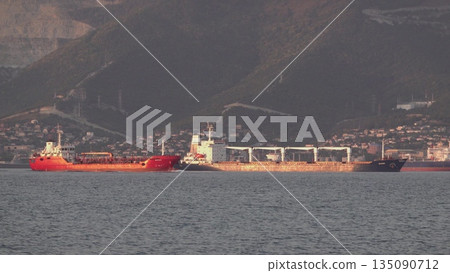August 24, 2025: Large cargo ship entering the port of Novorossiysk, Russia, on the Black Sea, illustrating maritime transport, industrial shipping and coastal infrastructure 135090712
