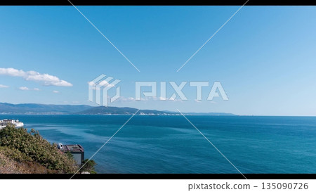 View of Tsemesskaya Bay from Mount Koldun in Myskhako near Novorossiysk, Russia, overlooking the Black Sea coastline, port area and mountainous landscape View of Tsemesskaya Bay from Mount Koldun in Myskhako near Novorossiysk, Russia, overlooking the Black Sea coastline, port area and mountainous landscape 135090726
