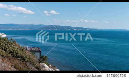View of Tsemesskaya Bay from Mount Koldun in Myskhako near Novorossiysk, Russia, overlooking the Black Sea coastline, port area and mountainous landscape View of Tsemesskaya Bay from Mount Koldun in Myskhako near Novorossiysk, Russia, overlooking the Black Sea coastline, port area and mountainous landscape 135090728