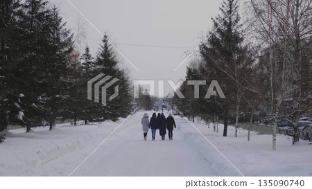 28 December 2025, Barnaul, Russia. People walk along the central city alley in winter, enjoying snowy urban streets, seasonal outdoor activities, and cityscape. 135090740
