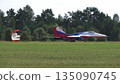 25 July 2021, Russia, Zhukovsky. Russian aerobatic team Swifts flying MiG-29 jets lands with drag chutes deployed at MAKS 2021 air show, demonstrating precision flying and military aviation. 135090745