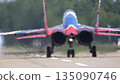 25 July 2021, Russia, Zhukovsky. Russian aerobatic team Swifts flying MiG-29 jets lands with drag chutes deployed at MAKS 2021 air show, demonstrating precision flying and military aviation. 135090746