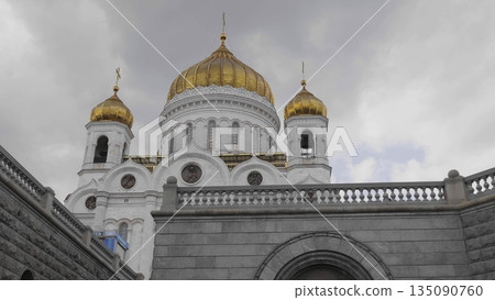 Russia, Moscow. View of the Cathedral of Christ the Savior, showing the exterior architecture, surroundings, and cityscape of the capital. 135090760