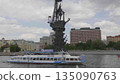 Russia, Moscow. Monument to Peter I celebrating the 300th anniversary of the Russian Navy with a passenger river cruise boat passing by, tourists on board, city and river view. 135090763
