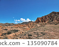 Scenic landscape of dusty brown mountains and hills under a vast blue sky 135090784