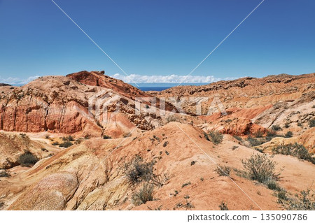Expansive view of colorful desert landscape showing eroding hills 135090786