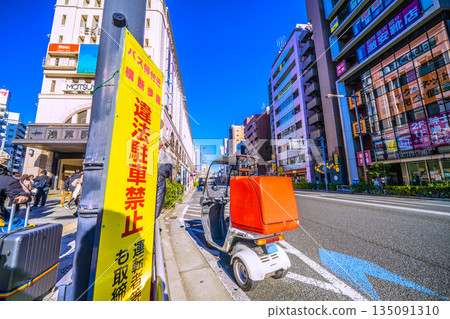 Tokyo cityscape in Japan: "Near bus stops, crosswalks, illegal parking prohibited..." Dangerous abandoned motorcycles at intersections that cause accidents 135091310