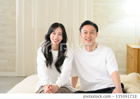 A man and a woman having a conversation in a bedroom at night A man and a woman having a conversation in a bedroom at night 135091718