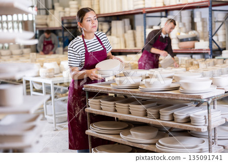Young woman posing with ceramic blanks Young woman posing with ceramic blanks 135091741
