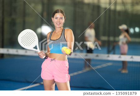 Young woman posing on tennis court 135091879