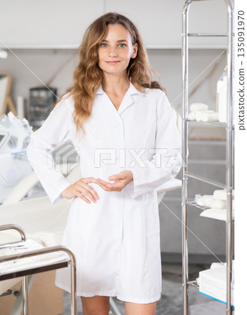 Young female doctor taking notes in medical room 135091970