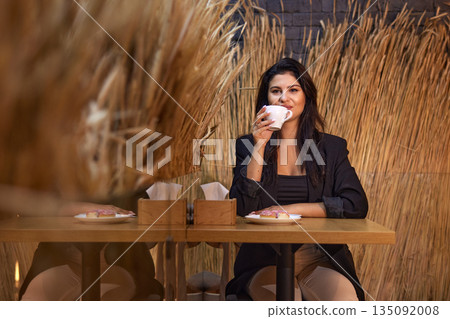coffee cup, autumn atmosphere, wheat motif. In cozy cafe adorned with wheat decor and warm lighting, woman relaxes with cup coffee, capturing essence autumn. coffee cup, autumn atmosphere, wheat motif. In cozy cafe adorned with wheat decor and warm lighting, woman relaxes with cup coffee, capturing essence autumn. 135092008