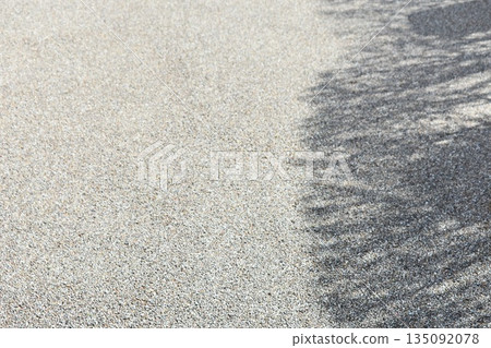 Gravel ground background material where the shade of trees falls Gravel ground background material where the shade of trees falls 135092078