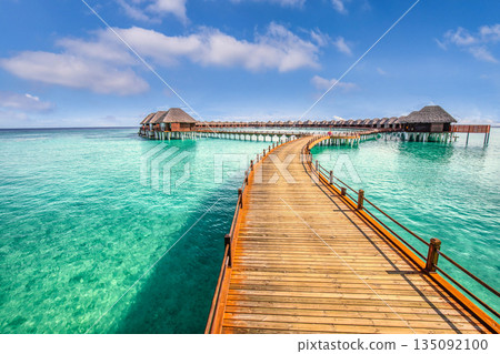 Panoramic Maldives beach landscape with luxury water villa resort wooden pier or jetty tropical panorama turquoise lagoon summer vacation travel tourism exotic island getaway background scenic holiday 135092100