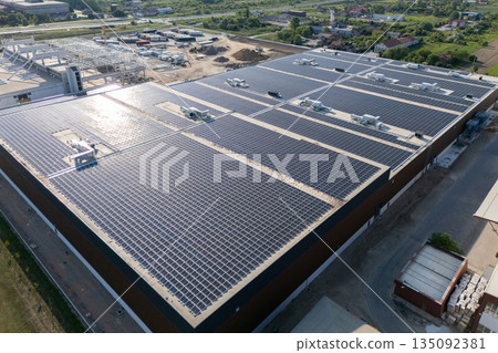 Logistics centers with solar panels on roofs under construction. Aerial view. 135092381