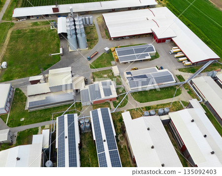 Modern poultry farm with solar panels. Factory using renewable energy. Aerial view. Modern poultry farm with solar panels. Factory using renewable energy. Aerial view. 135092403
