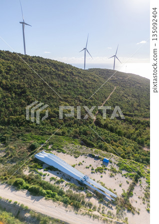Wind turbines on the top of the mountain with spare blades on the ground. Wind generator repairing Wind turbines on the top of the mountain with spare blades on the ground. Wind generator repairing 135092404