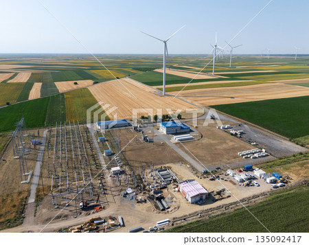 Aerial view of wind turbines with electric power station. Aerial view of wind turbines with electric power station. 135092417