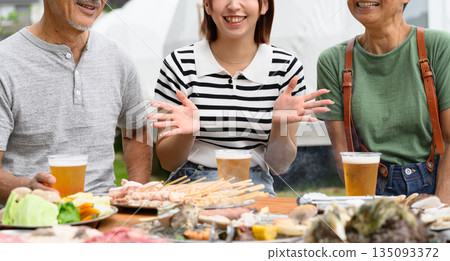 Three generations enjoying an outdoor BBQ [Photography cooperation: Oki Seaside Resort Miyabi] 135093372