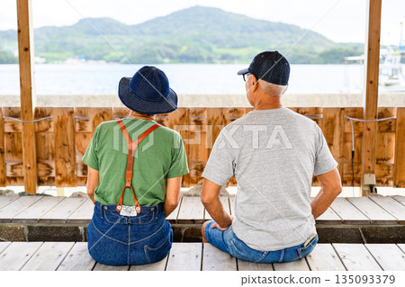 An elderly couple looking out at the sea (Photo courtesy of Oki Seaside Resort Miyabi) An elderly couple looking out at the sea (Photo courtesy of Oki Seaside Resort Miyabi) 135093379