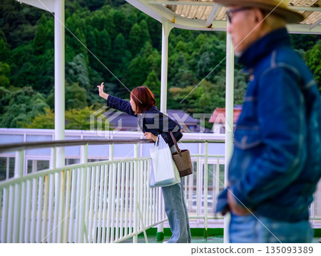 Woman waving from a ferry Woman waving from a ferry 135093389