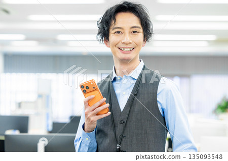 A man operating the latest smartphone 135093548