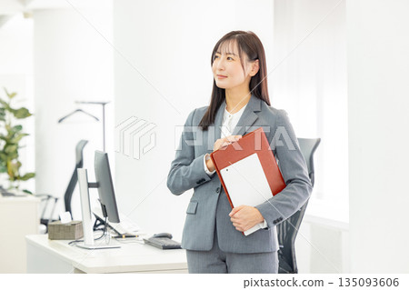Businesswoman holding a file Businesswoman holding a file 135093606