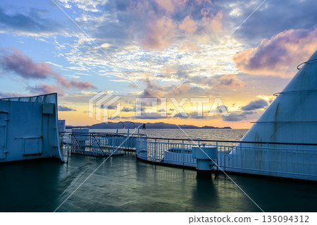 Sunset from the deck of a ship Sunset from the deck of a ship 135094312