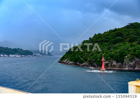 Red light beacon on the sea Red light beacon on the sea 135094319