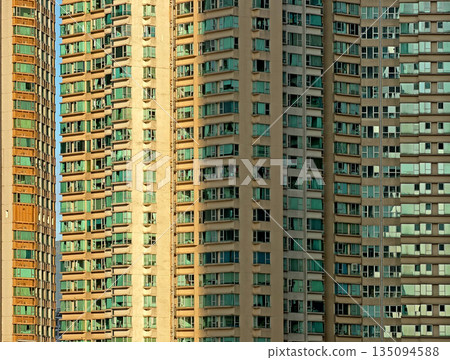 Rows of identical apartment building with many windows under the bright sun Rows of identical apartment building with many windows under the bright sun 135094588
