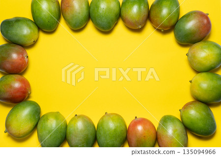 Bright summer yellow fruit background, ripe fresh mango frame and text space. 135094966