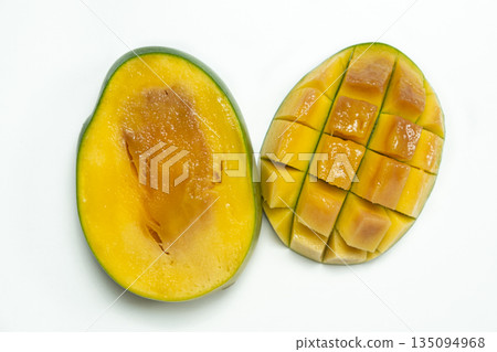 Inside of a very ripe mango sliced in half on white background Inside of a very ripe mango sliced in half on white background 135094968