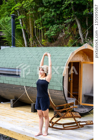A woman stretching outdoors [Photo courtesy of Oki Seaside Resort Miyabi] 135095067