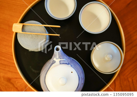 Japanese tea, tea utensils, Japanese aesthetics, quiet evening drink, minimalist composition Japanese tea, tea utensils, Japanese aesthetics, quiet evening drink, minimalist composition 135095095