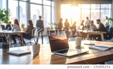 Businesspeople working on laptops at a conference table in an airport Businesspeople working on laptops at a conference table in an airport 135095253
