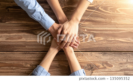 Group of people holding hands together in support and teamwork Group of people holding hands together in support and teamwork 135095352