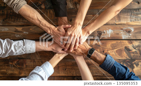Group of people holding hands together in support and teamwork Group of people holding hands together in support and teamwork 135095353