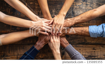 Group of people holding hands together in support and teamwork 135095355