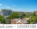 View of roofs of urban highrise buildings and cottages 135095388