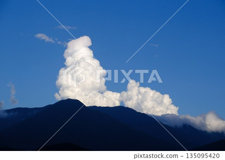 山脊上方積雨雲和藍天逐漸形成。 135095420