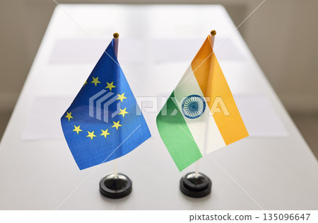 EU and India desk flags symbolizing diplomacy, negotiation and bilateral meeting 135096647