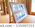 Construction site with large wooden door leaning against wall on building project 135097153