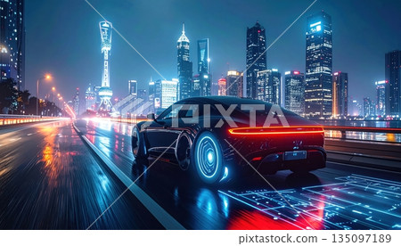 Urban traffic flows through the downtown city street at night as cars drive past illuminated skyscrapers and office buildings in a high speed motion across the highway Urban traffic flows through the downtown city street at night as cars drive past illuminated skyscrapers and office buildings in a high speed motion across the highway 135097189