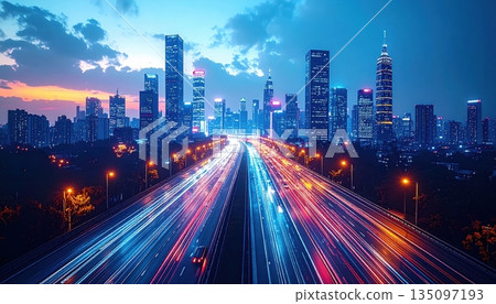 A vibrant night cityscape of Hong Kong features motion blur from traffic on a highway winding through downtown skyscrapers and urban architecture in China A vibrant night cityscape of Hong Kong features motion blur from traffic on a highway winding through downtown skyscrapers and urban architecture in China 135097193