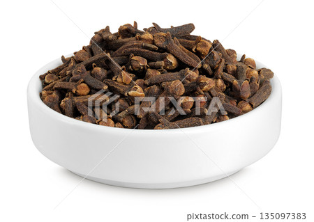 dry spice cloves in ceramic bowl isolated on white background. dry spice cloves in ceramic bowl isolated on white background. 135097383