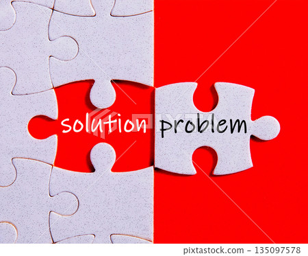 Jigsaw puzzle pieces forming words solution problem on red background 135097578